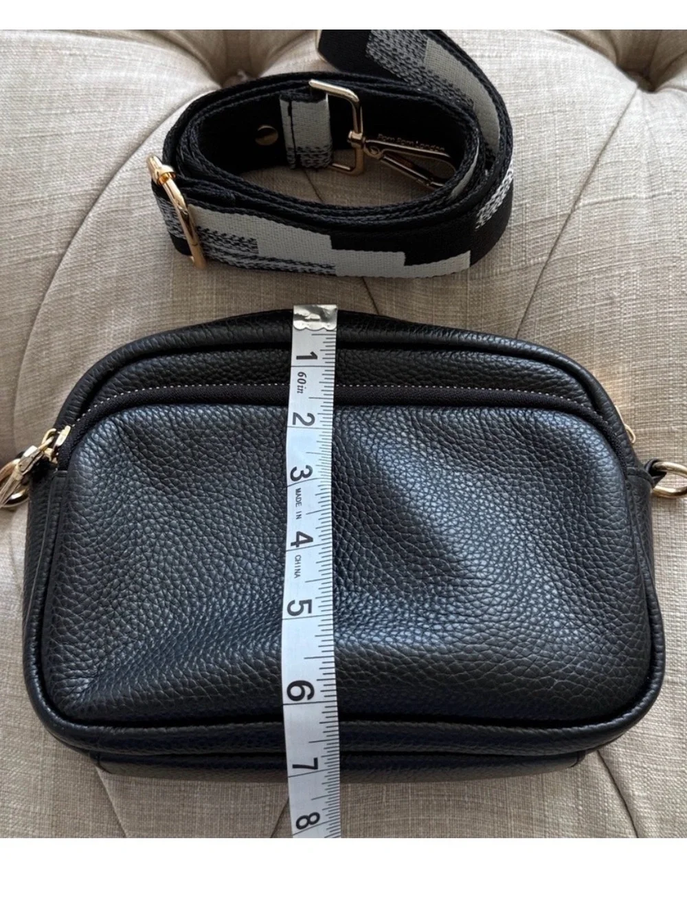 Compact Black Pebble Crossbody with Patterned Strap